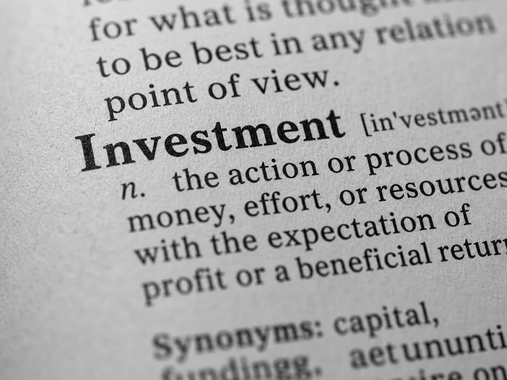 Close-up of the word Investment in a printed dictionary